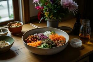 A meal consisting of veggie bibimbap, fresh salad dressed with edible flowers, bean chili and a kombucha tea. Minimally processed and naturally fermented food. Generative AI photo