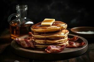 A stack of golden, fluffy pancakes, drizzled with maple syrup and topped with a pat of butter, served on a rustic, wooden plate with crispy bacon. Generative AI. photo