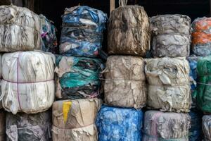 Piles of recycled materials paper, plastic, glass and metal awaiting processing into new eco-friendly products. A reminder of the importance of reducing waste and reusing resources. Generative AI photo