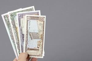 Old Lebanese money in the hand on a gray background photo