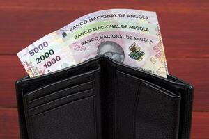 Angolan money in the black wallet photo