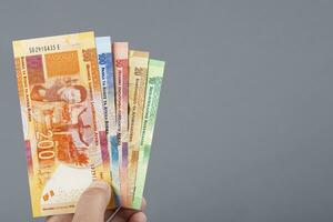 South African money in the hand on a gray background photo