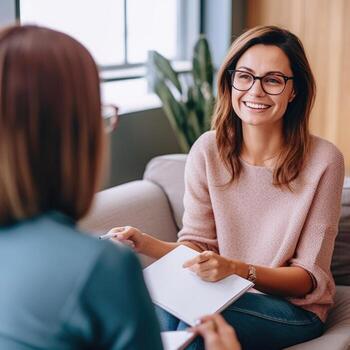 smiling psychologist with notebook and patient at psychotherapy session. AI Generated photo