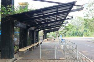 empty bus stop. midday. no vehicles photo