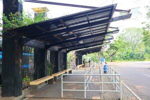 empty bus stop. midday. no vehicles photo