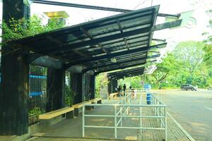 empty bus stop. midday. no vehicles photo