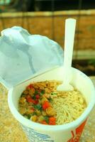 Eat Instant Noodles with Plastic Fork, complete with vegetables photo