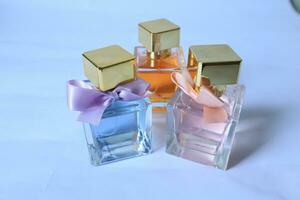 three types of perfume on white isolated background photo