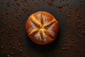 a baked bread on a dark background photo