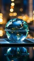 A glass globe on a laptop symbolizes a global business perspective Vertical Mobile Wallpaper AI Generated photo