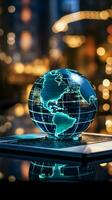 A glass globe on a laptop symbolizes a global business perspective Vertical Mobile Wallpaper AI Generated photo