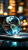 A glass globe on a laptop symbolizes a global business perspective Vertical Mobile Wallpaper AI Generated photo