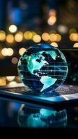 A glass globe on a laptop symbolizes a global business perspective Vertical Mobile Wallpaper AI Generated photo