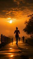 Running enthusiasts silhouette against the backdrop of a radiant sunrise Vertical Mobile Wallpaper AI Generated photo
