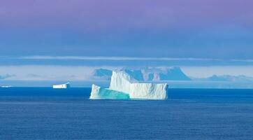 Iceberg seen from cruise ship vacation near Greenland coast in Arctic circle near Ilulissat Disko Bay photo