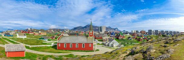 Typical architecture of Greenland capital Nuuk with colored houses located near fjords and icebergs photo