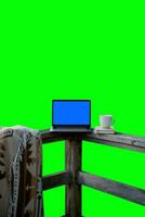 Crafting the Perfect Workspace, Utilizing a Customizable Green Screen, a Laptop, and a Cup of Coffee Set Against a Stunning Natural Background. Attain Your Desired Work-Life Harmony. photo
