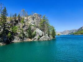 Clear blue Tropical water with green vegetation and a shore photo