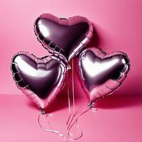 heart shaped balloons on pink background photo