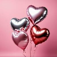 heart shaped balloons on pink background photo