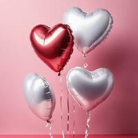 heart shaped balloons on pink background photo