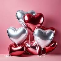 heart shaped balloons on pink background photo