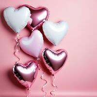 heart shaped balloons on pink background photo