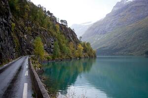 Road near Loen and Stryn in Norway,Lovatnet in october,norwegian nature,lake with turquoise water on rainy day, travel destination photo