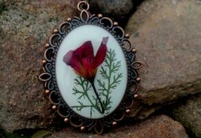 elegant handmade resin jewelry, pressed flowers of geranium in epoxy resin photo