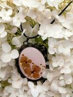 elegant handmade resin jewelry, pressed flowers of hydrangea in epoxy resin photo