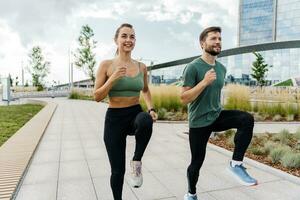 Runners are a young couple training on the street. Athletes are friends of running exercises.A fitness instructor and a woman training in sportswear and sneakers. photo