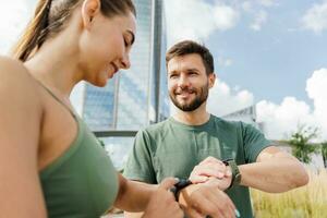 rutina de ejercicio personas utilizar aptitud reloj y aplicación para ejercicio resultados. un mujer y un hombre en aptitud ropa para correr. físico educación juntos, familia Pareja sano estilo de vida. foto