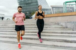 A woman and a man in fitness running clothes. Physical education together, family couple healthy lifestyle. People workout trainer use fitness watch and app for exercise results. photo