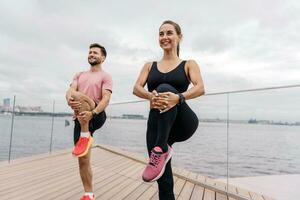 Fitness friends exercises for a healthy lifestyle. Sports people, training together. A woman and a man doing running sports are getting ready to run. Use a fitness watch and a bracelet photo