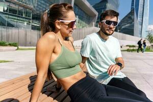 Leisure Runners a young couple training outside. Athletes are friends of running exercises. A fitness instructor and a woman training in sportswear and sneakers. photo