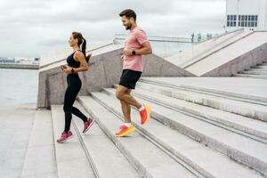 Friends are fitness people who train together.  Runners are getting ready for the race. Using smart watches for fitness, sportswear and running shoes. photo