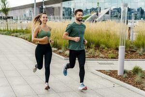 Running in the fresh air. A woman and a man doing sports running. Friends run together. Fitness exercises for a healthy lifestyle. Sports people, training together. photo