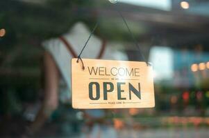 Woman entrepreneur with Open sign in cafe shop , small business concept photo