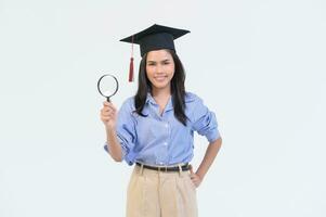 Portrait of happy Beautiful woman in graduation gown over white background photo