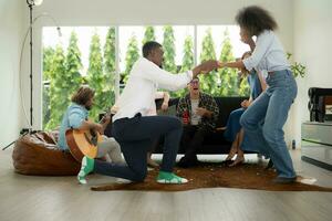 A group of multiethnic friends having fun at a party and witness their friend's marriage proposal. photo