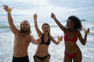 Group of friends having fun on the beach. Young women having fun on the beach. photo