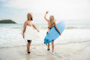 Two surfers giving high five on the beach. Two surfers having fun on the beach. photo