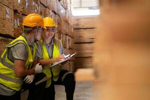 Both of workers work in a woodworking factory, Checking inventory the wood in the wooden warehouse photo