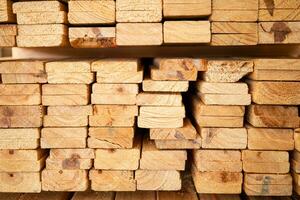 Wooden stacked in a warehouse, close-up. Wooden industrial background photo