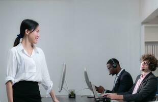 Portrait of business people wearing headset working actively in office. Call center, telemarketing, customer support agent provide service on telephone video conference call. photo