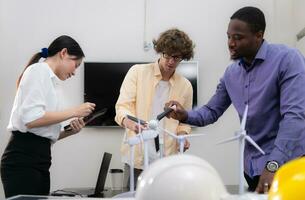 Group of multi-national team of architects and designers is meeting to brainstorm designs for wind turbines to capture wind energy and convert it into electrical energy. photo