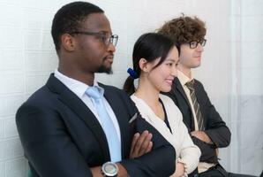 Portrait of confident business team standing in office. Multiethnic group. photo