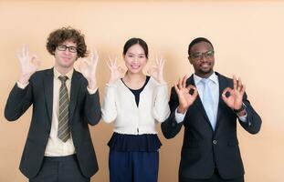 Portrait of group multi ethnic business people together showing ok hand sign with fingers photo