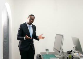 Young african american business man working at modern office with computer photo