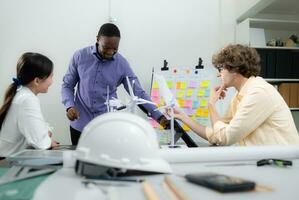 Group of multi-national team of architects and designers is meeting to brainstorm designs for wind turbines to capture wind energy and convert it into electrical energy. photo